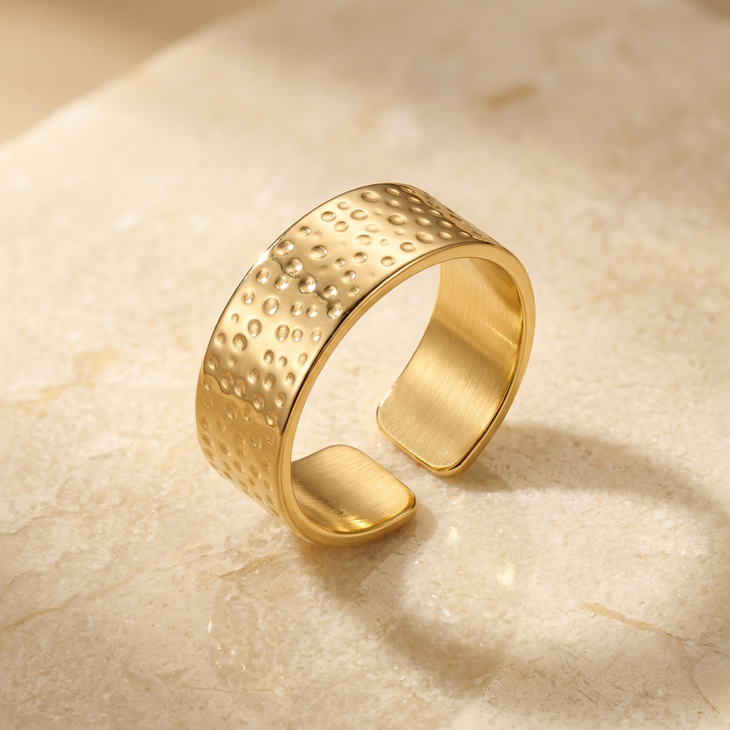 Gold-tone hammered free-size ring with open-back gap on ivory stone.